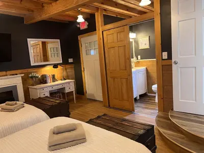 a large room with two beds and a bathroom at Triple See NY Now - Sleeps 41 -15 Mins to NYC in Union City