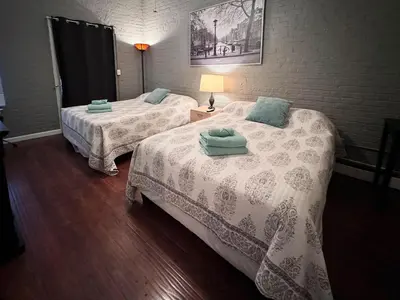 a room with two beds with towels on them at Mega Stunning Skyline View - APT 4-5 Combination - 6 Bedroom - Sleeps 25 - 15 mins to NYC in Union City