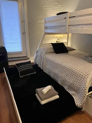 a bedroom with a bunk bed with a towel on the floor at Mega Stunning Skyline View - APT 4-5 Combination - 6 Bedroom - Sleeps 25 - 15 mins to NYC in Union City