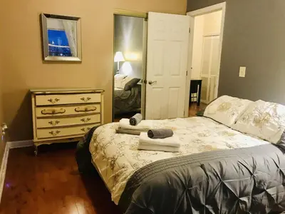 a bedroom with a bed and a dresser and a mirror at Mega Stunning Skyline View - APT 4-5 Combination - 6 Bedroom - Sleeps 25 - 15 mins to NYC in Union City