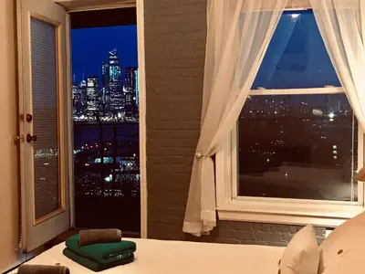 a bedroom with a window with a view of the city at Mega Trade Stunning View - APT 3-4 Combination in Union City
