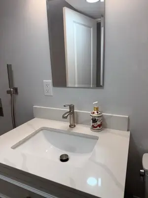 a bathroom with a white sink and a mirror at Private Studio in Park House in Jenkintown