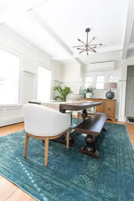 a living room with a table and a rug at Spacious Beach Vibe Newark's Hidden Gem in Newark