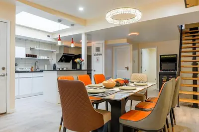 a kitchen and dining room with a table and chairs at Spacious 3BR Oasis with Patio & Arcade Fun in Philly in Philadelphia