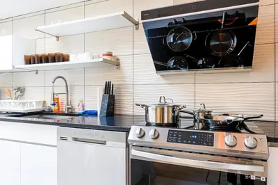 a kitchen with two pots and pans on a stove at Spacious 3BR Oasis with Patio & Arcade Fun in Philly in Philadelphia