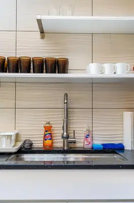 a kitchen counter with a sink and a foss at Spacious 3BR Oasis with Patio & Arcade Fun in Philly in Philadelphia