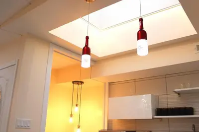 a kitchen with three lights hanging from the ceiling at Spacious 3BR Oasis with Patio & Arcade Fun in Philly in Philadelphia