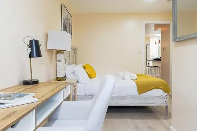 a bedroom with a bed and a desk with a chair at Spacious 3BR Oasis with Patio & Arcade Fun in Philly in Philadelphia