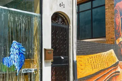 a door with a painting on the side of a building at Spacious 3BR Oasis with Patio & Arcade Fun in Philly in Philadelphia