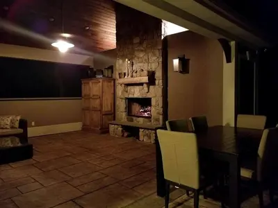 a living room with a table and a fireplace at Glamorous Cottage Rental with Outdoor Lounge and Pool on 40 Acres in Pine Bush, New York in Pine Bush