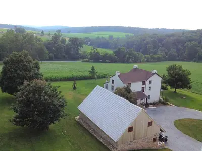 an overhead view of a house with a white barn at Stylish Cottage Loft Rental on a Farm in Lancaster County near Philadelphia, Pennsylvania in Christiana