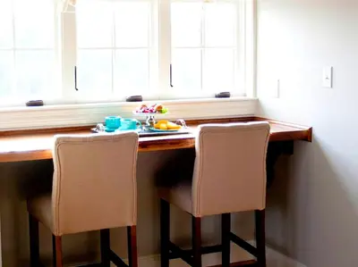 a table with two chairs and a plate of food on it at Stylish Cottage Loft Rental on a Farm in Lancaster County near Philadelphia, Pennsylvania in Christiana