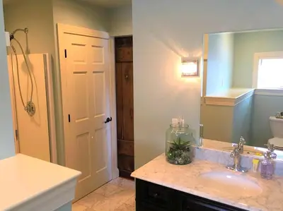 a bathroom with a sink and a mirror at Stylish Cottage Loft Rental on a Farm in Lancaster County near Philadelphia, Pennsylvania in Christiana