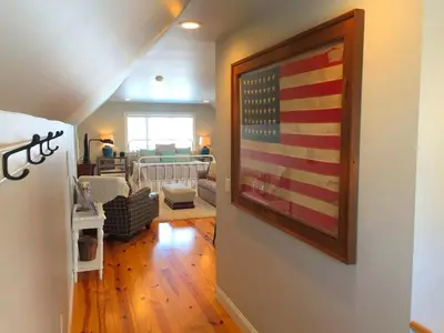 a living room with an american flag on the wall at Stylish Cottage Loft Rental on a Farm in Lancaster County near Philadelphia, Pennsylvania in Christiana
