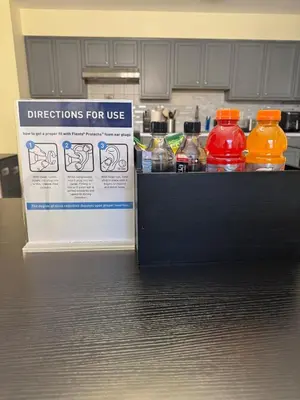 a drink dispenser in a kitchen with bottles of water at 3BR Stay for Crews & Families in Elizabeth