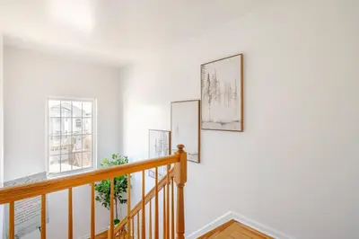 three paintings on a white wall in a staircase in a house at 3BR Stay for Crews & Families in Elizabeth