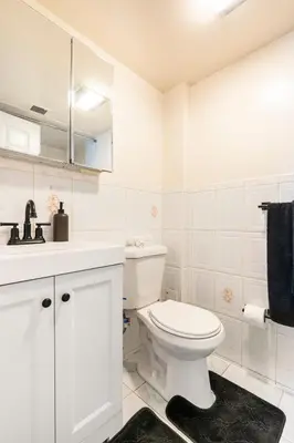 a white bathroom with a toilet and a sink at 2BR Stay for Crews & Families in Elizabeth
