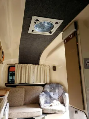 a room with a couch and a window in an rv at Unique Caravan for Vintage Glamping Experience in Pine Bush, New York in Pine Bush
