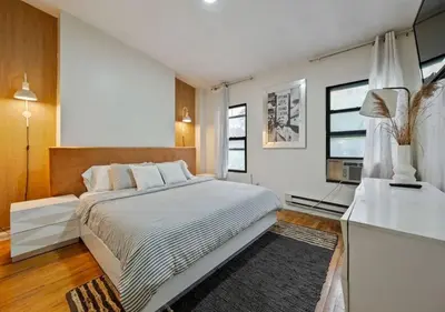 a bedroom with a large bed and a desk at Three Bedroom Rental in Midtown West , June to Aug 90 days stay required in New York