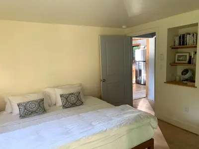 a bedroom with a white bed with pillows on it at Gorgeous Cottage for Two, Overlooking Pond on 20 acres, Glamping in Pennsylvania in Spring Mills