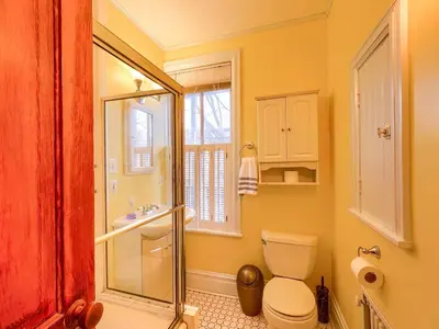 a bathroom with a toilet and a glass shower at Cozy Home in Historic Harrisburg in Harrisburg