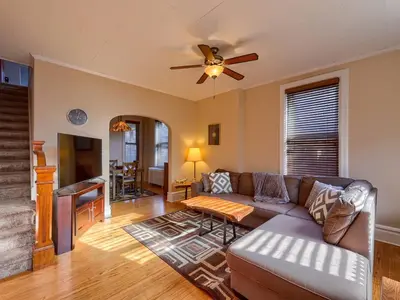 a living room with a couch and a ceiling fan at Cozy Home in Historic Harrisburg in Harrisburg