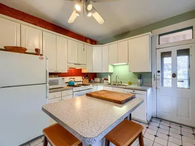 a kitchen with white cabinets and a white refrigerator at Cozy Home in Historic Harrisburg in Harrisburg