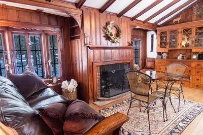 a living room with a couch and a fireplace at Enchanted Fox Dell Cottage in Monticello