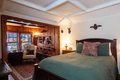 a bedroom with a bed and a desk and a chair at Enchanted Fox Dell Cottage in Monticello
