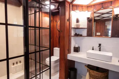 a bathroom with a toilet and a sink at Enchanted Fox Dell Cottage in Monticello