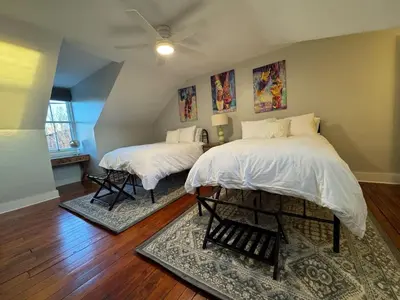a bedroom with two beds and a ceiling fan at Heart of Midtown Home on Penn St - Pet Friendly in Harrisburg
