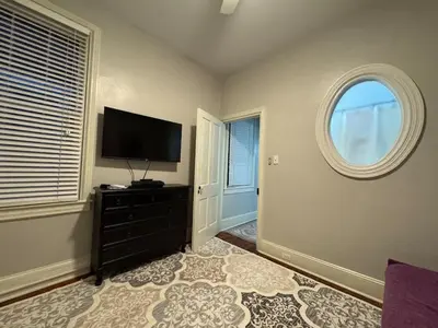 a living room with a flat screen tv and a window at Heart of Midtown Home on Penn St - Pet Friendly in Harrisburg