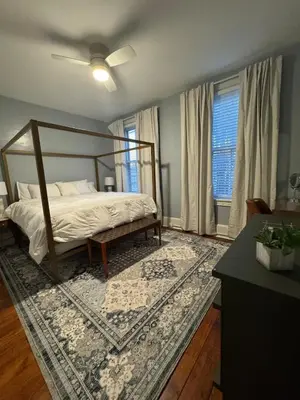 a bedroom with a canopy bed and a rug at Heart of Midtown Home on Penn St - Pet Friendly in Harrisburg