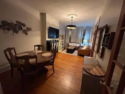 a living room with a dining room table and a couch at Heart of Midtown Home on Penn St - Pet Friendly in Harrisburg