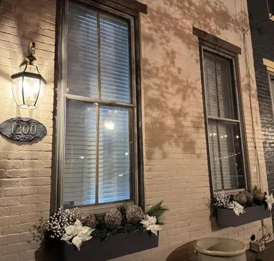 a couple of windows with flowers and plants on them at Heart of Midtown Home on Penn St - Pet Friendly in Harrisburg