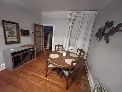 a dining room with a wooden table and chairs at Heart of Midtown Home on Penn St - Pet Friendly in Harrisburg
