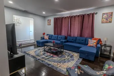 a living room with a blue couch and a flat screen tv at Cozy Apt Lake Park Station Airport Hospital NJ NYC in Rahway