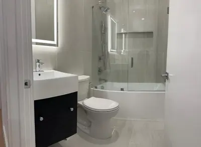 a bathroom with a toilet and a sink and a shower at Modern 3BR,2BA Apartment in Jersey City, Easy Access to Manhattan in Jersey City