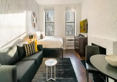 a living room with a couch and a bed at Studio for 2! Heart of Midtown! in New York