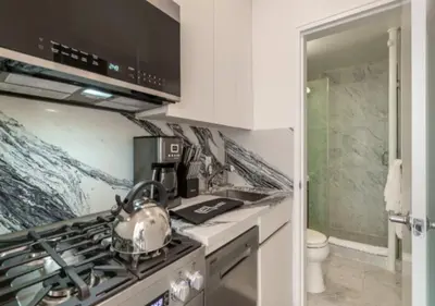 a kitchen with a stove with a tea kettle on it at Studio for 2! Heart of Midtown! in New York