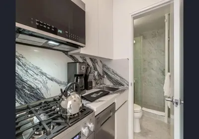 a kitchen with a tea kettle on a stove at Modern Studio Apartment in NYC! in New York