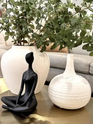 a black statue sitting on a table next to a vase at Luxurious Home Away from Home ! 30 minutes to NYC ! in Rochelle Park