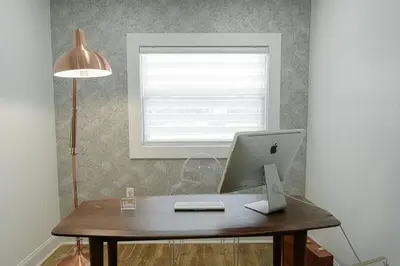 a desk with a laptop computer and a lamp at Luxurious Home Away from Home ! 30 minutes to NYC ! in Rochelle Park