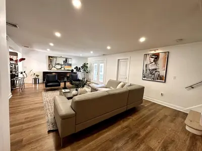a living room with a couch and a table at Luxurious Home Away from Home ! 30 minutes to NYC ! in Rochelle Park