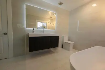 a bathroom with a sink and a toilet and a mirror at Luxurious Home Away from Home ! 30 minutes to NYC ! in Rochelle Park