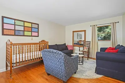 a living room with a couch and a crib at Mountain Retreat Stunning Views Hot Tub Fire Pit in Mehoopany
