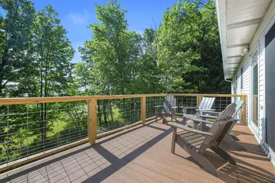 a balcony with two chairs and a bench on it at Mountain Retreat Stunning Views Hot Tub Fire Pit in Mehoopany