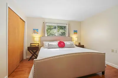 a bedroom with a bed with a red flower on it at Mountain Retreat Stunning Views Hot Tub Fire Pit in Mehoopany
