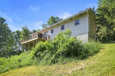 a house on the side of a hill at Mountain Retreat Stunning Views Hot Tub Fire Pit in Mehoopany