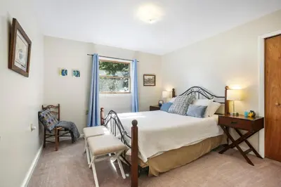 a bedroom with a bed and a desk and a window at Mountain Retreat Stunning Views Hot Tub Fire Pit in Mehoopany